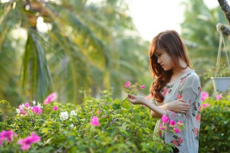 An Asian woman with trees in the backround